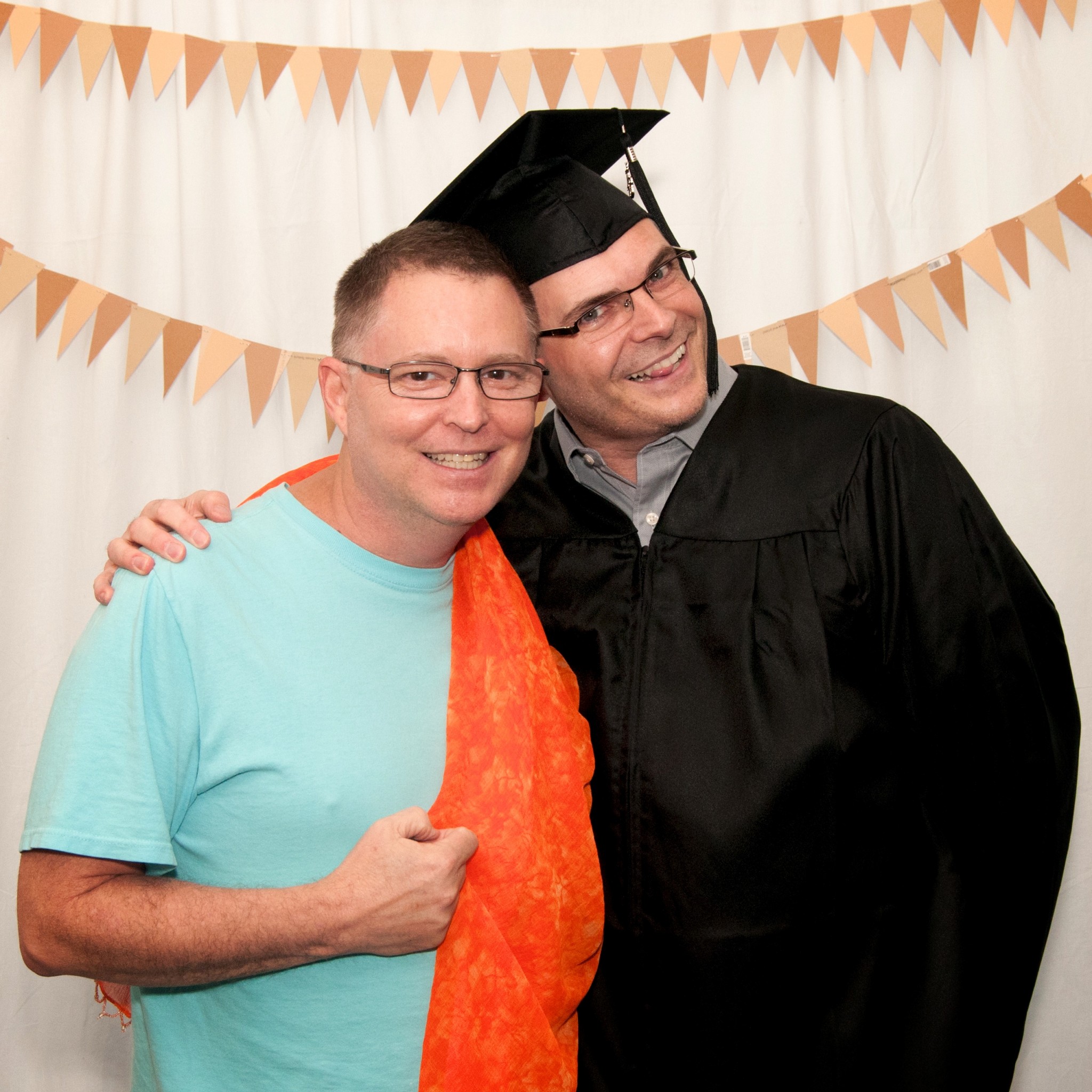 Andy's wearing an orange pashmina at a "fun photo" booth a photographer classmate of ours set up at our hooding ceremony. This was taken before I was hooded.